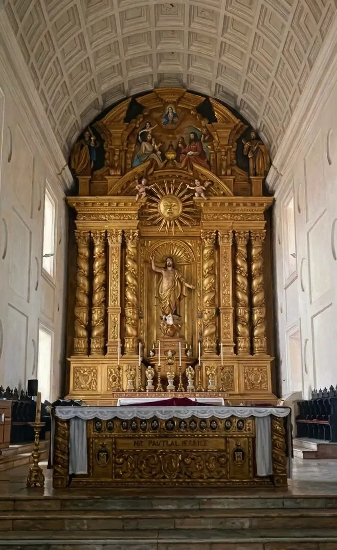 Interior of the Basilica of Bom Jesus in Old Goa with ornate sacred artwork and gilded decoration